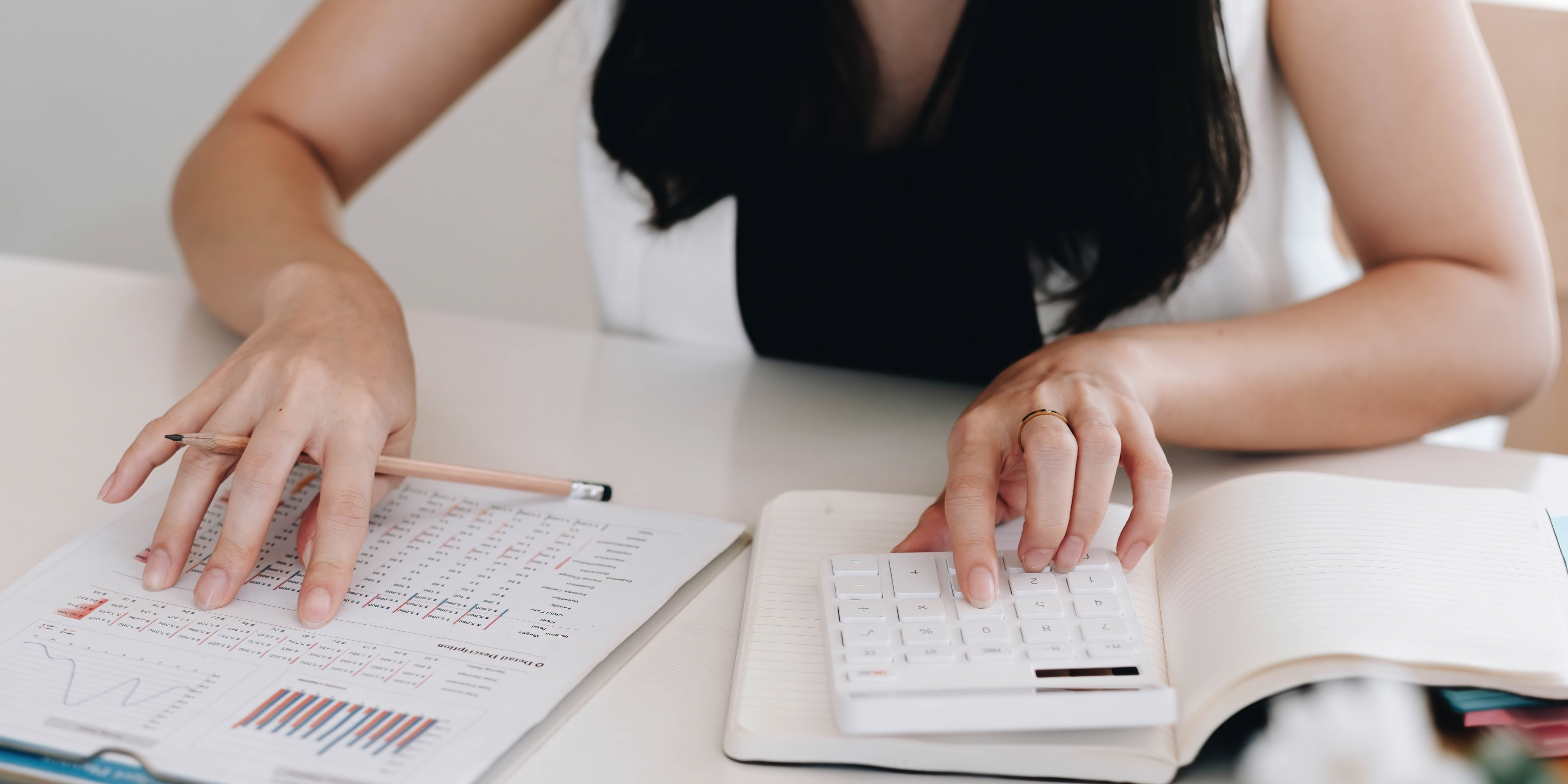 Accountant reviewing financial reports with a calculator