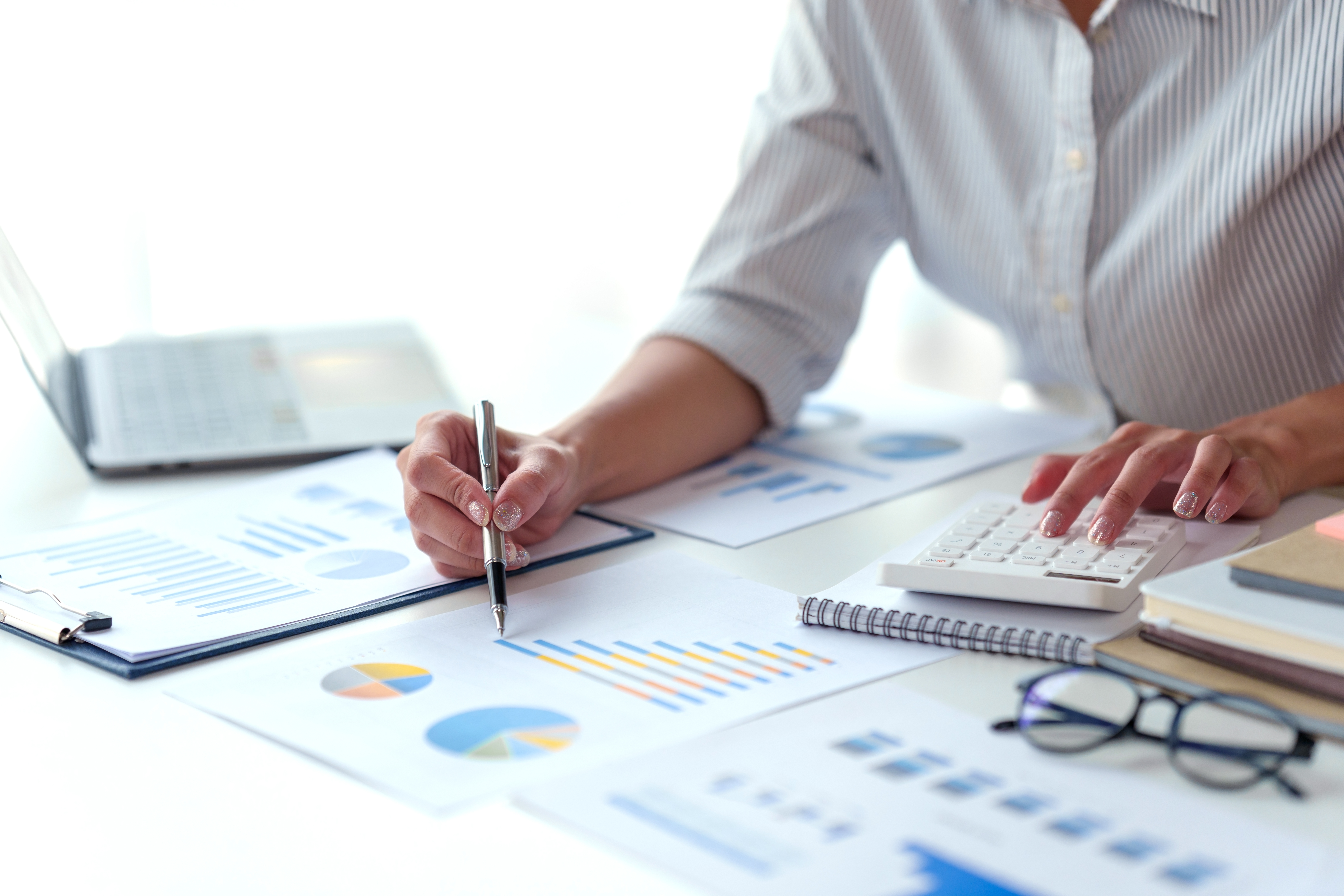 Business professional analyzing charts at a desk